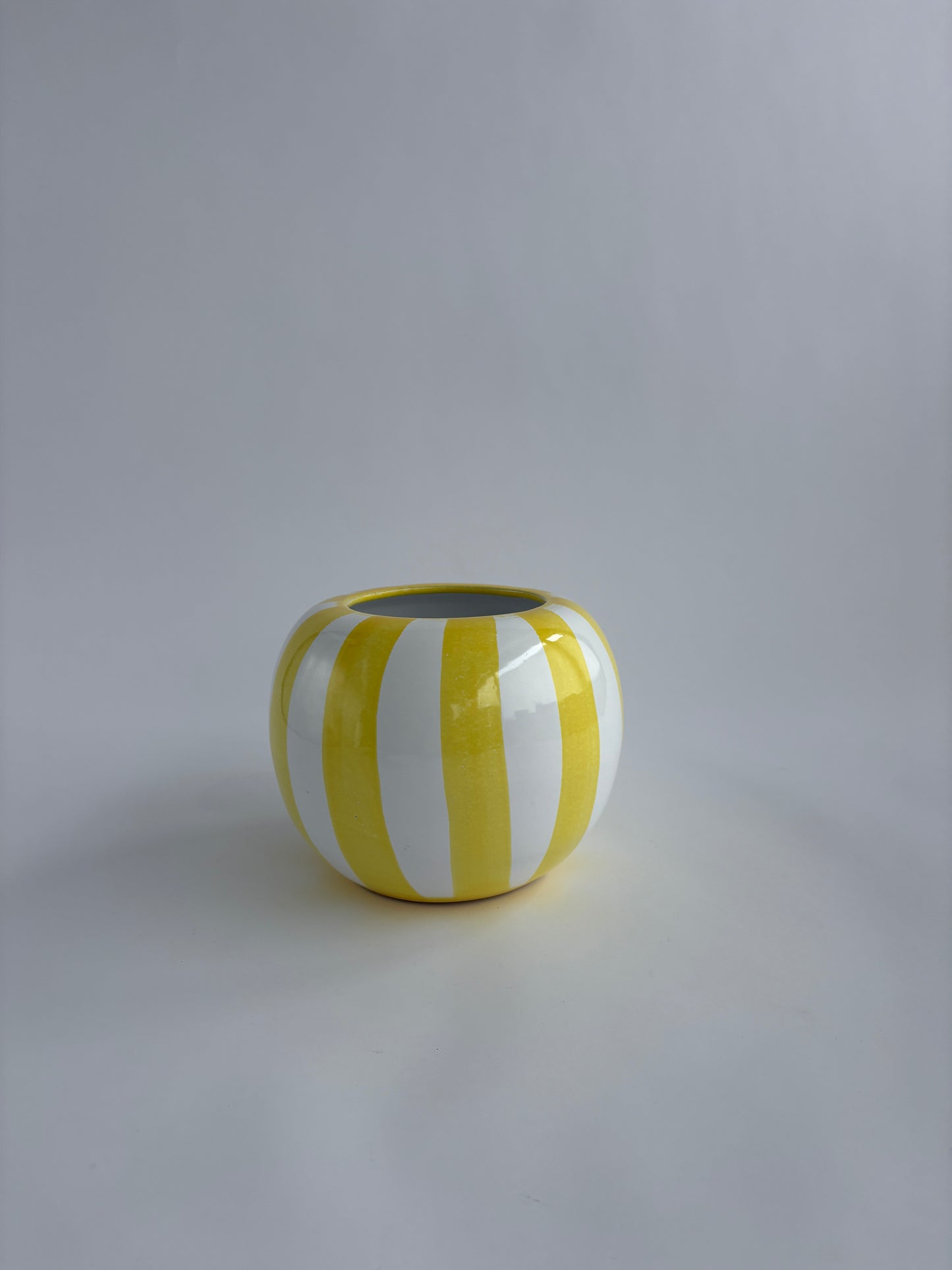 Yellow and white striped rounded vase