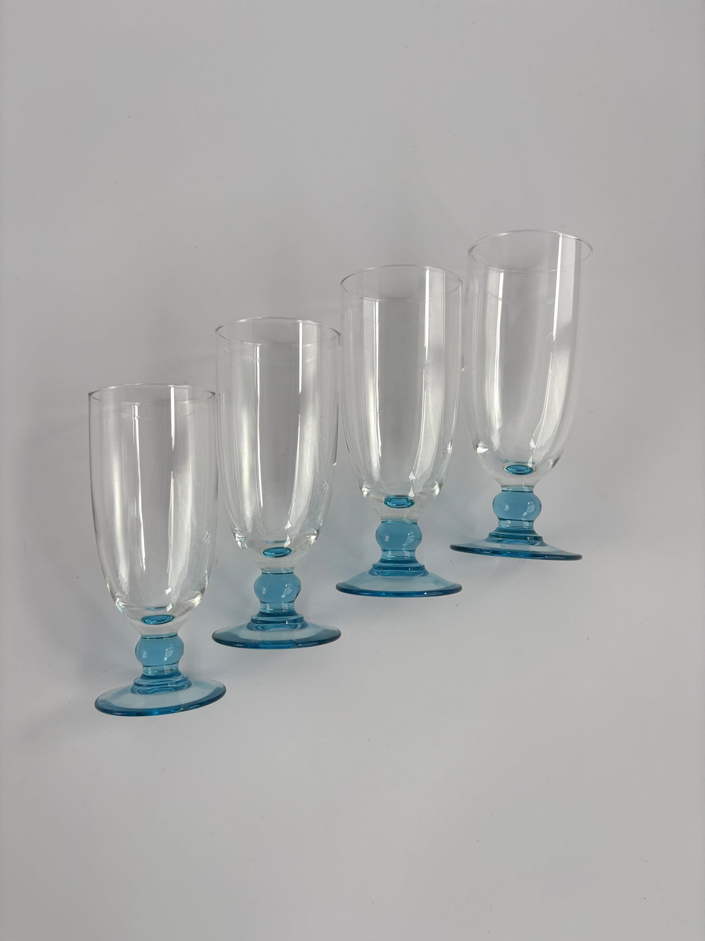 Set of 4 champagne glasses with light blue stems