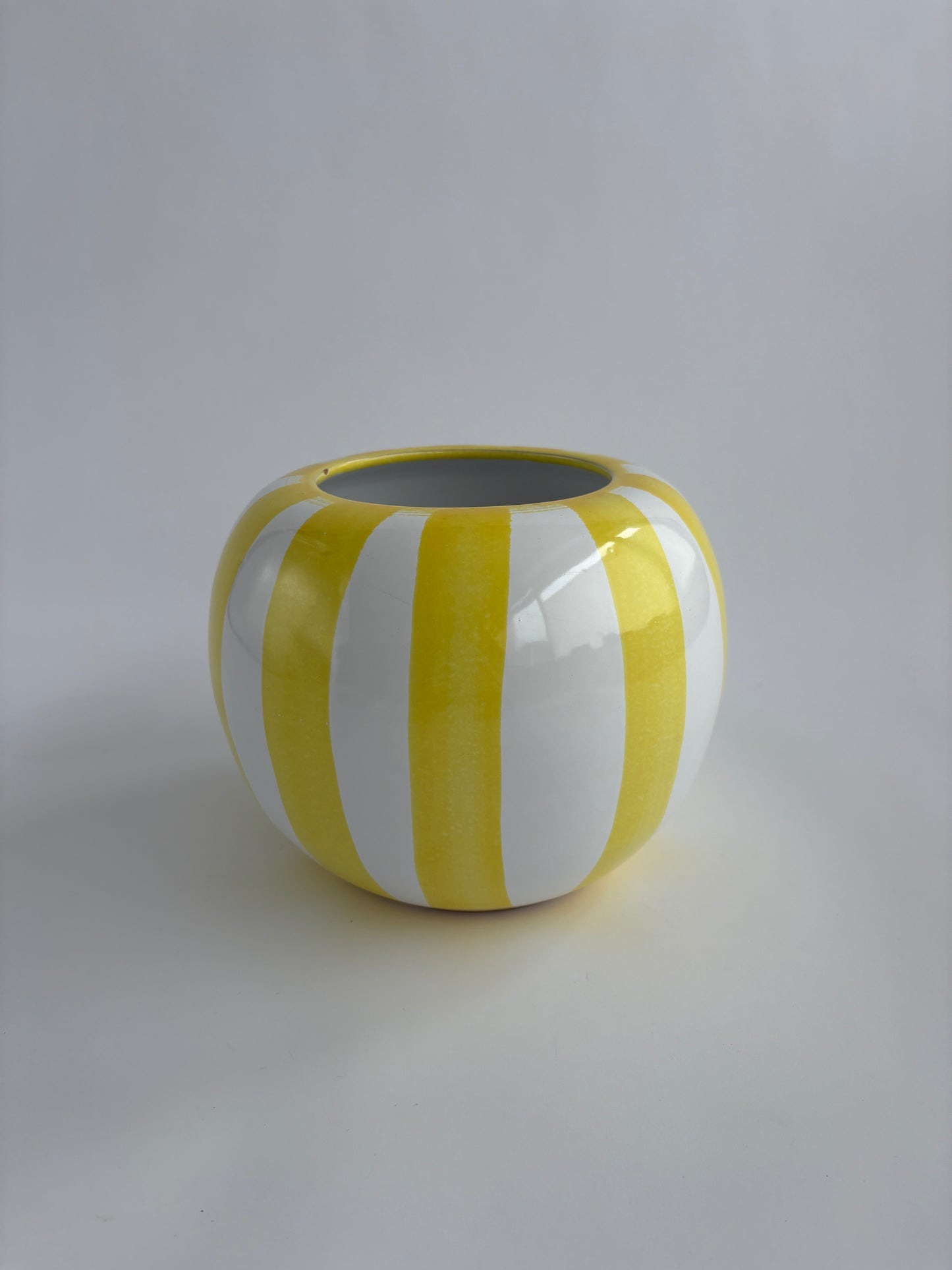 Yellow and white striped rounded vase