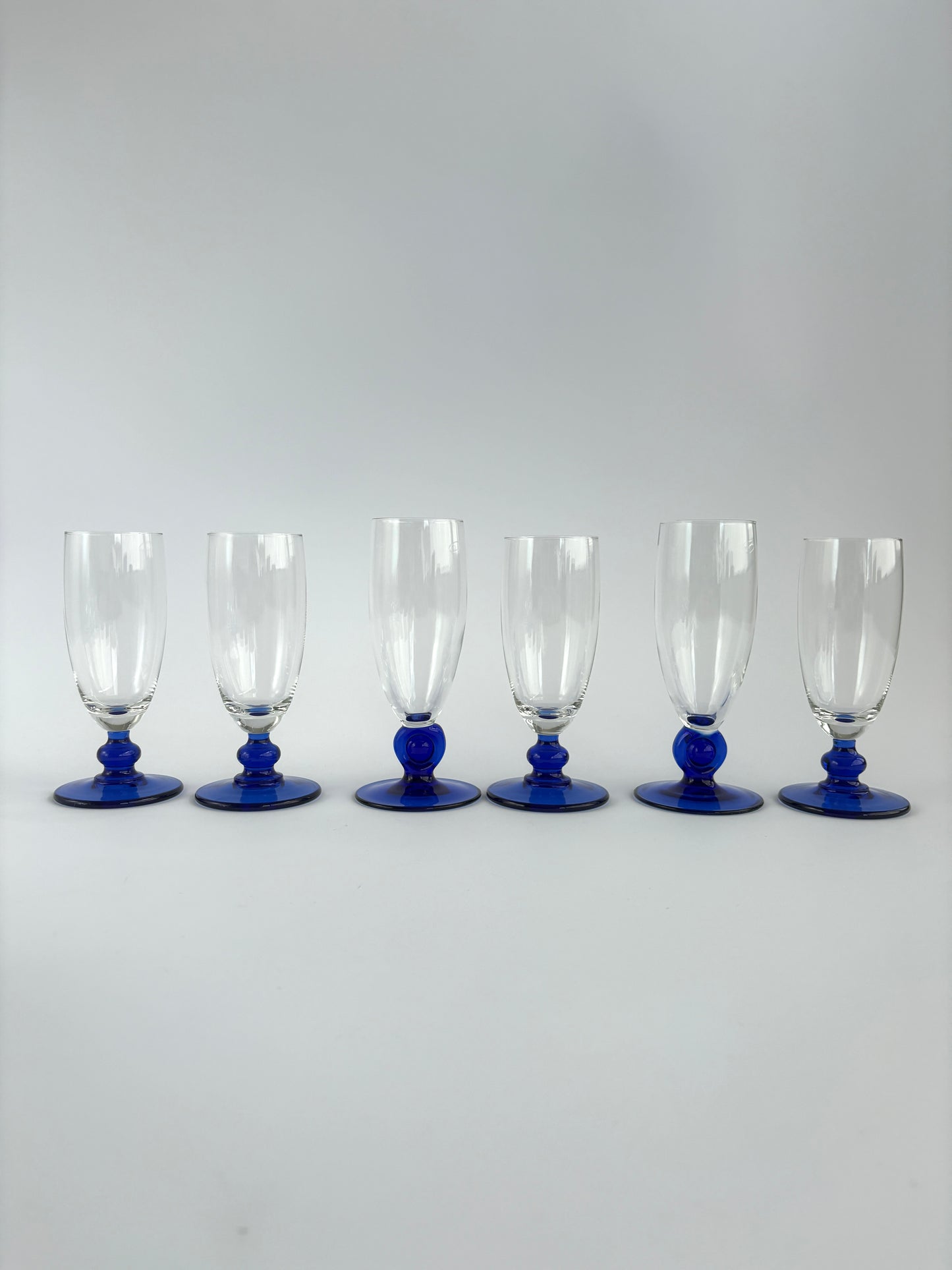 Set of 6 champagne glasses with dark blue stems