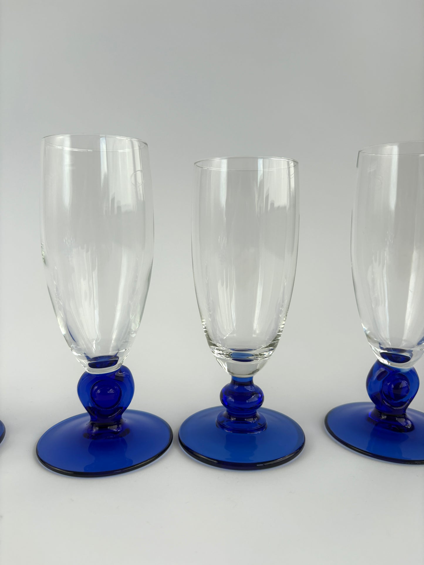 Set of 6 champagne glasses with dark blue stems