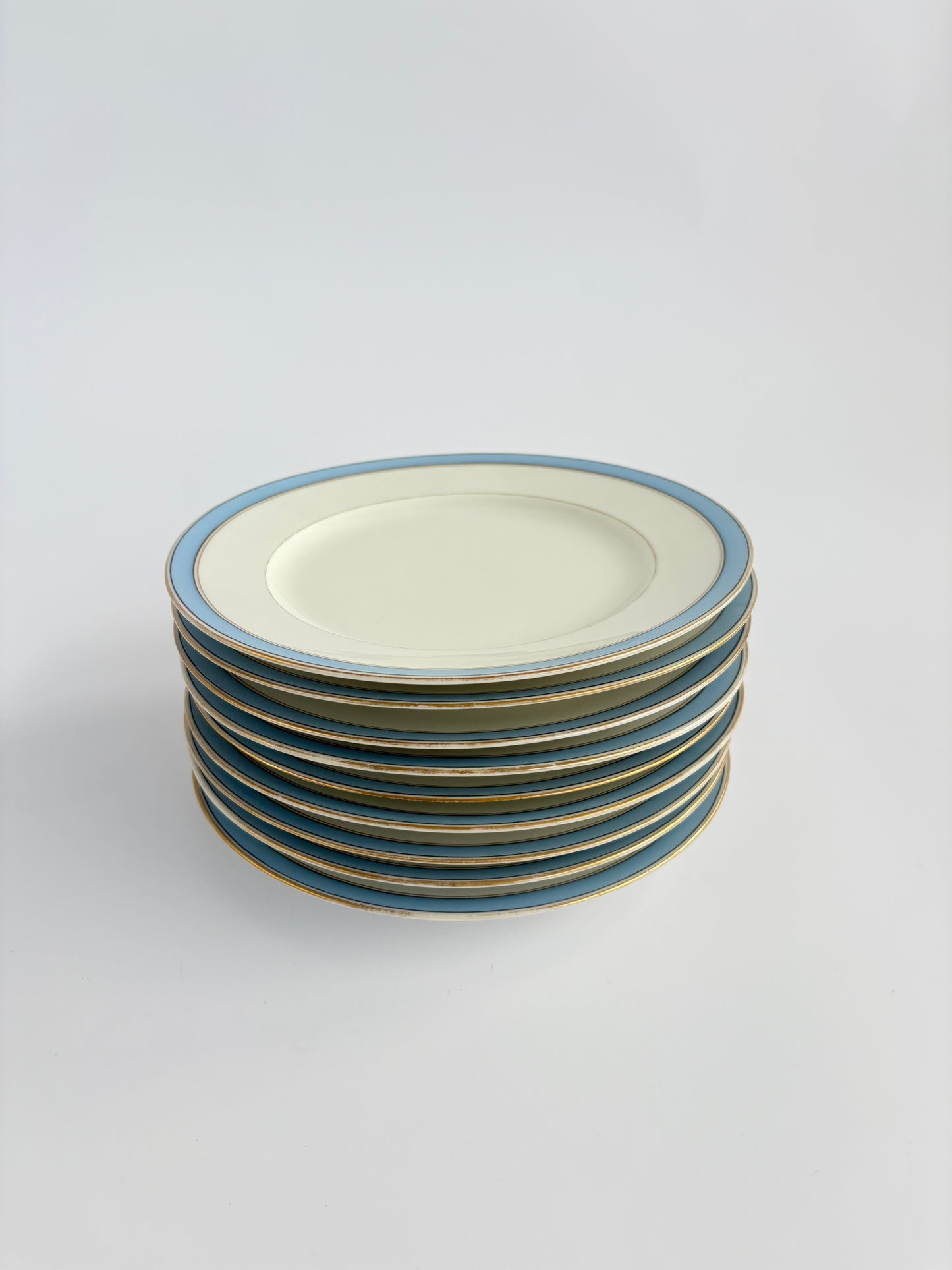 Set of 9 plates with blue and gold rim