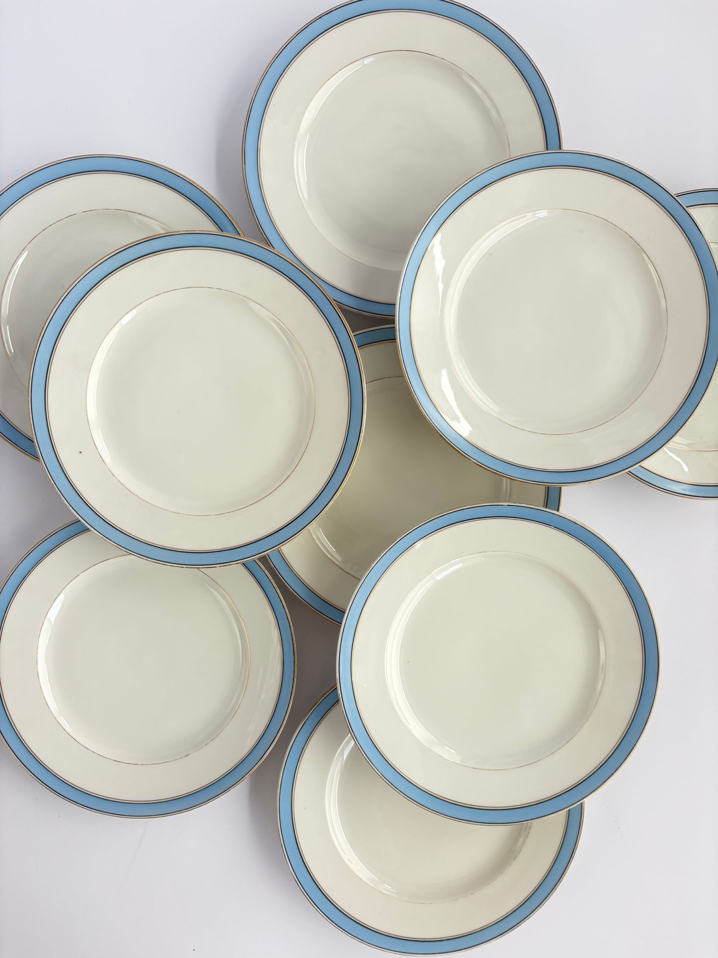 Set of 9 plates with blue and gold rim